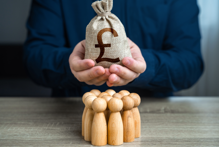 90476590 a man is holding a british pound sterling money bag over a group of people figurines political lobbying payment for labor and services generation of funds organization of