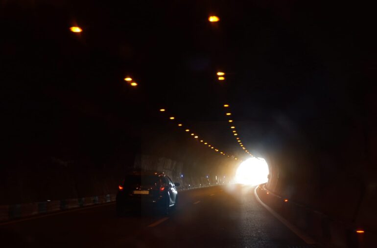 51343468 a car is moving towards the exit of the tunnel