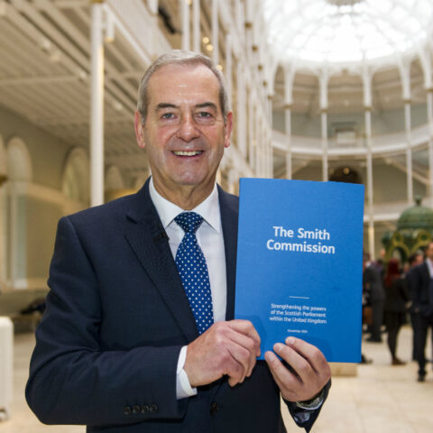 Lord Smith of Kelvin holding the Commission's report