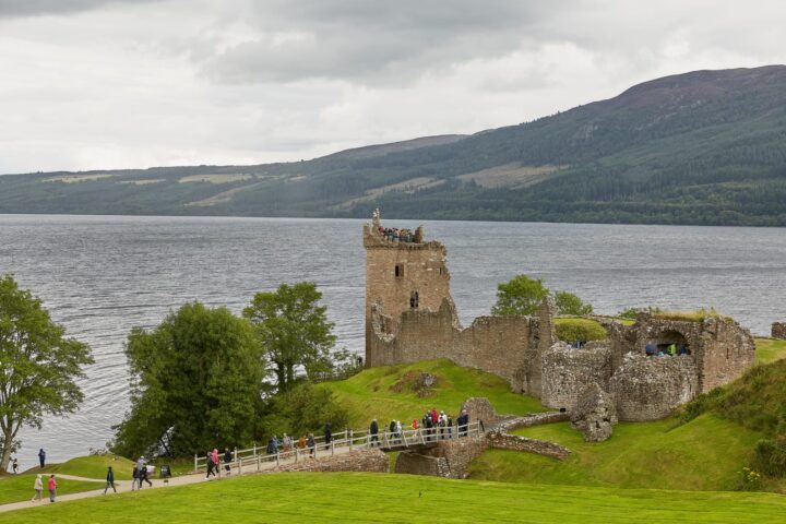 78050440 people enjoying vist at urquhart castle on the shore of loch ness scotland