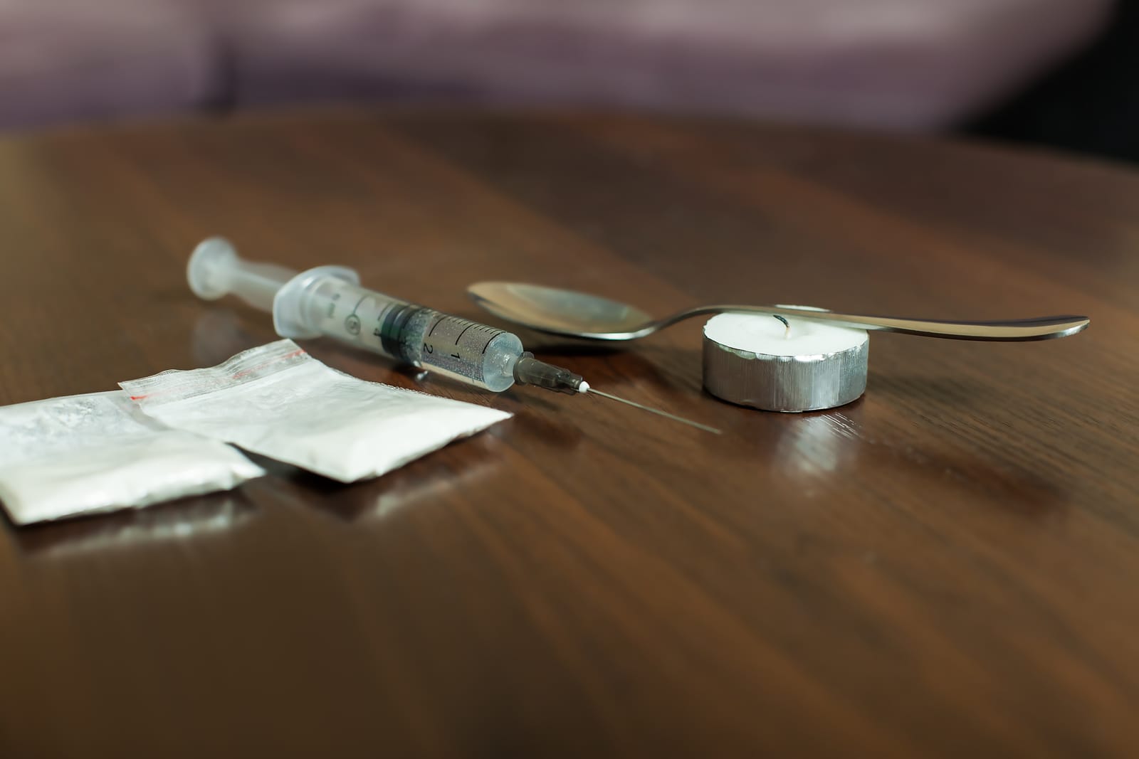 79021986 drug spoon and syringe on a table