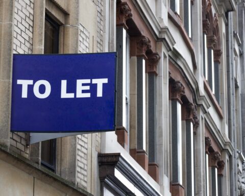 104176830 blue to let sign on a classic building facade