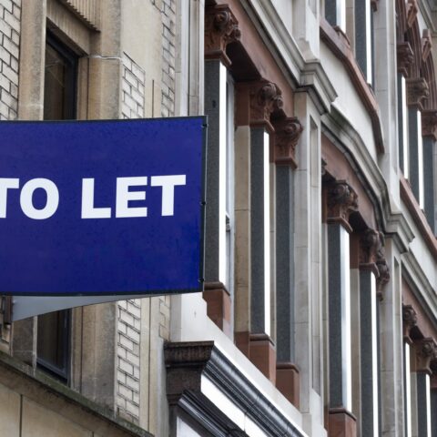 104176830 blue to let sign on a classic building facade