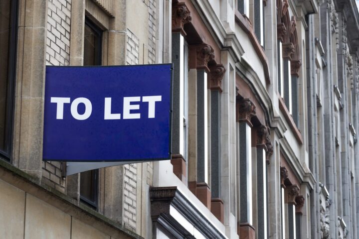 104176830 blue to let sign on a classic building facade