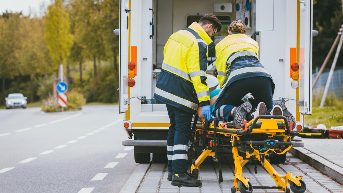Paramedic on stretcher fighting for life of injured woman