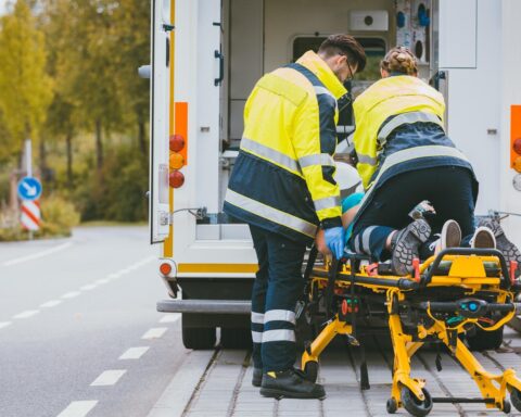 Paramedic on stretcher fighting for life of injured woman