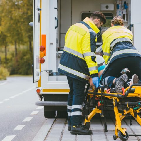 Paramedic on stretcher fighting for life of injured woman