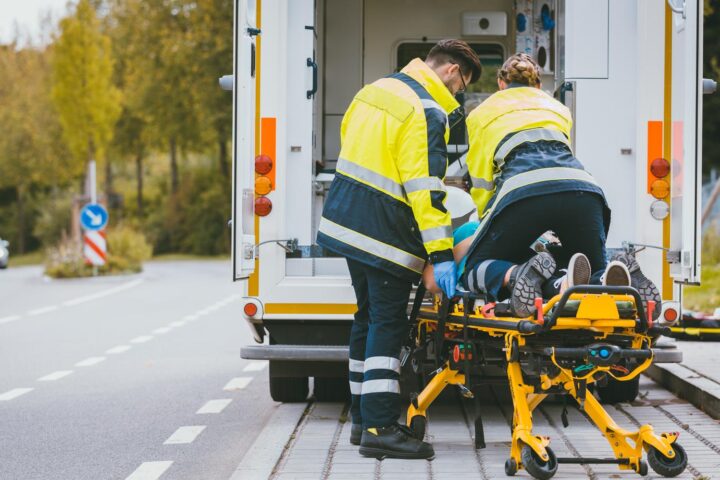 Paramedic on stretcher fighting for life of injured woman
