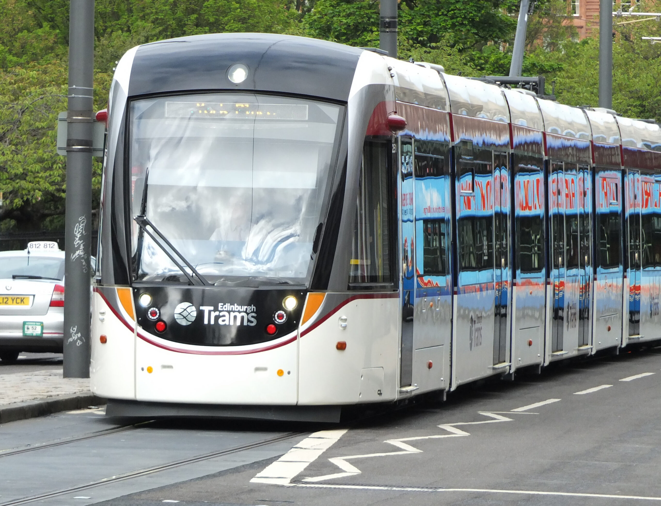 Caption: An Edinburgh tram on Princes Street. The city is considering the next major expansion of the network, with proposed routes towards Granton in the north and the Royal