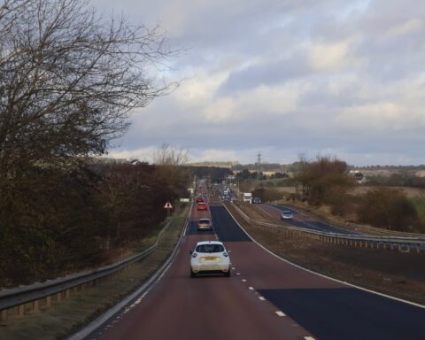 101636200 scotland 12 january 2026 busy rural highway with cars and guardrails under overcast sky