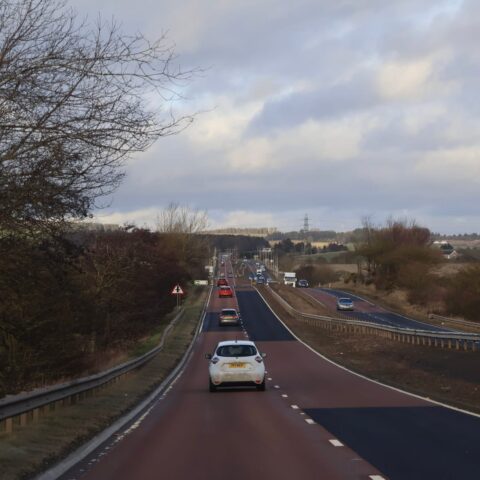 101636200 scotland 12 january 2026 busy rural highway with cars and guardrails under overcast sky