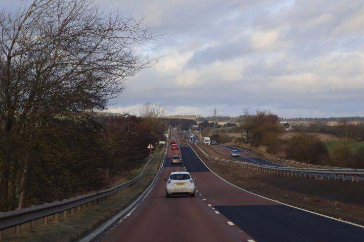 101636200 scotland 12 january 2026 busy rural highway with cars and guardrails under overcast sky