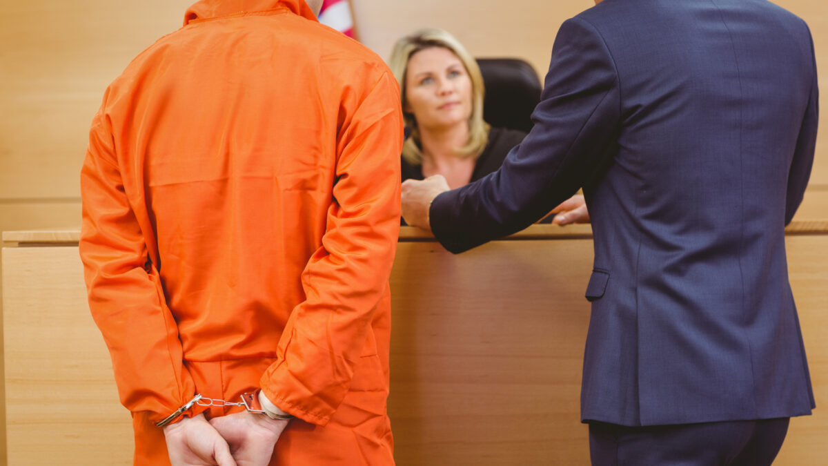 16682622 lawyer and judge speaking next to the criminal in handcuffs