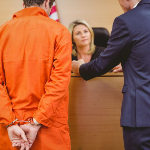 16682622 lawyer and judge speaking next to the criminal in handcuffs