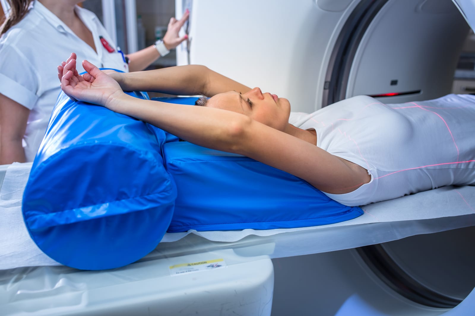 77725612 pretty young woman goiing through a computerized axial tomography cat scan medical testexamination in a modern hospital color toned image shallow dof