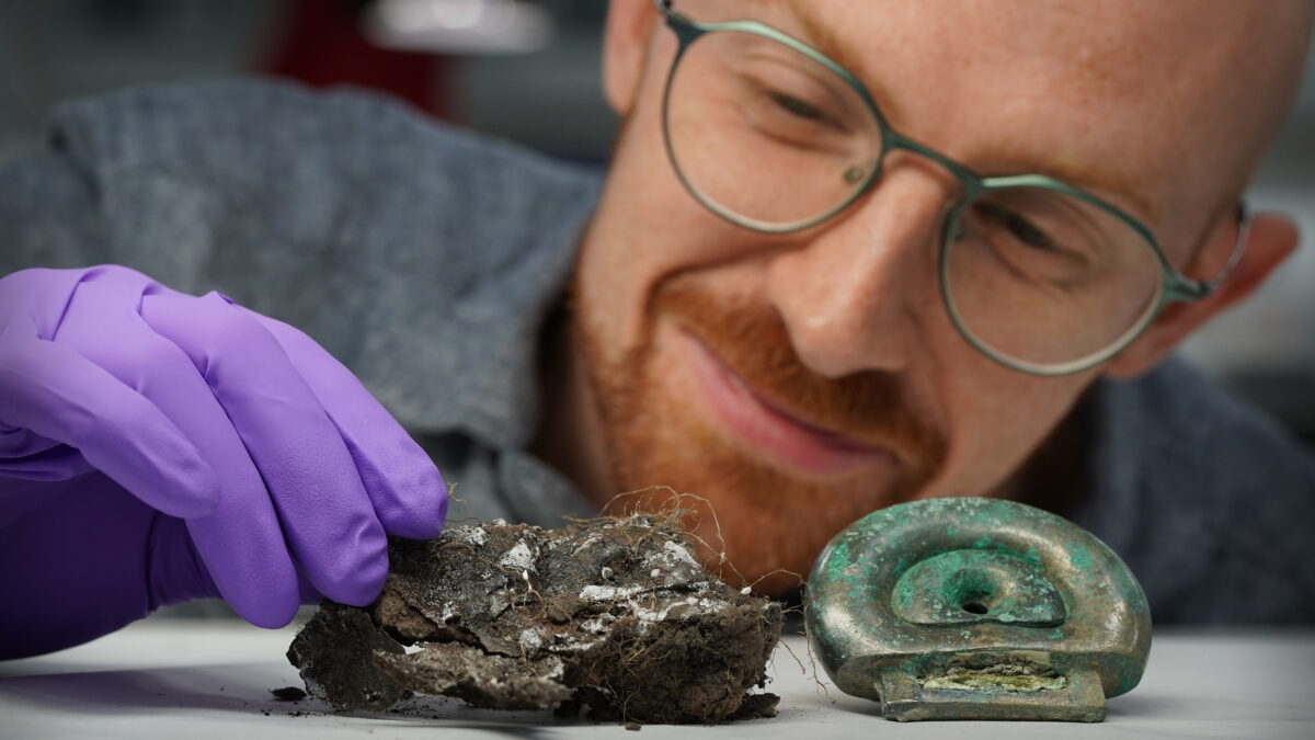 Dr Matthew Knight of National Museums Scotland with a clay mould from the Blyth Hoard and a fitting from the Peebles Hoard. Image by Stewart Attwood.