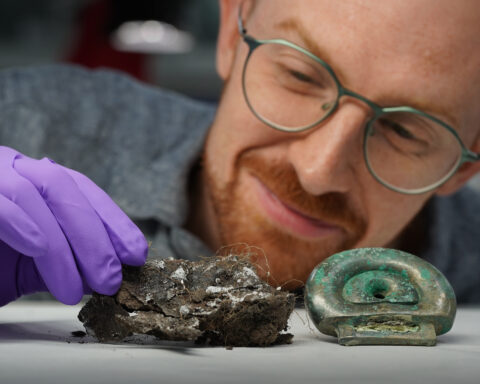 Dr Matthew Knight of National Museums Scotland with a clay mould from the Blyth Hoard and a fitting from the Peebles Hoard. Image by Stewart Attwood.
