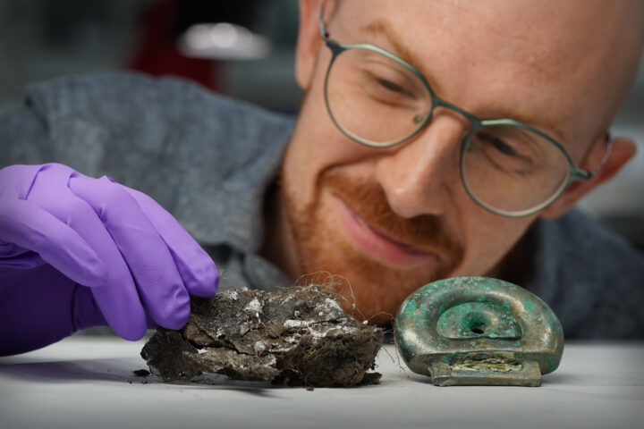 Dr Matthew Knight of National Museums Scotland with a clay mould from the Blyth Hoard and a fitting from the Peebles Hoard. Image by Stewart Attwood.